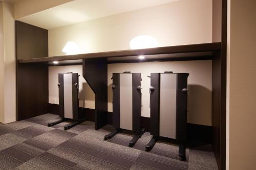 a row of toilet stalls in a bathroom at Dormy Inn Premium Nagoya Sakae in Nagoya