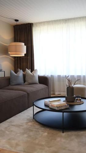 a living room with a couch and a table at Lovely villa at the foot of the Funen Alps in Fåborg