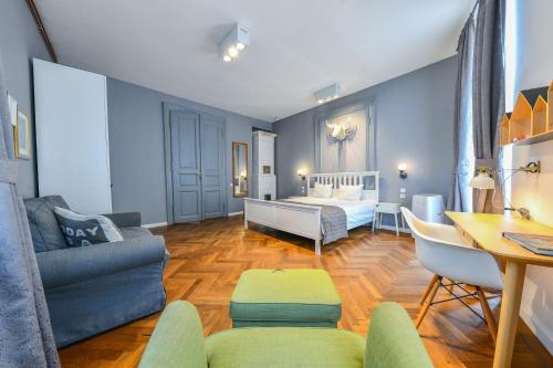 a living room with a bed and a couch at My Place Ferdinand in Cluj-Napoca