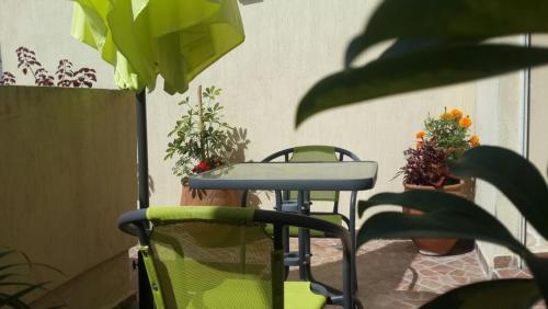 a table and two chairs on a patio with plants at One bedroom appartement with city view and terrace at Casablanca in Casablanca