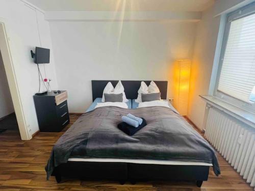 a bedroom with a large bed with two pillows at Nordsee Appartement in Hagen in Hagen