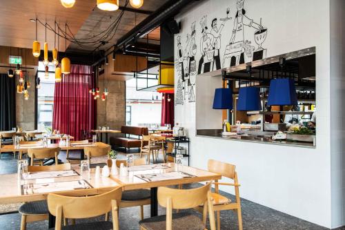 a dining room with wooden tables and chairs at Hotel Kitchen59 in Sofia