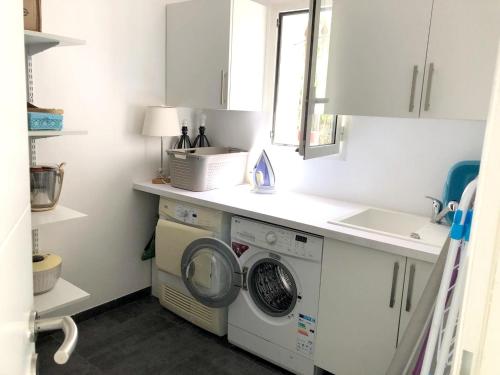 a kitchen with a washing machine and a sink at Villa pittoresque à Mougins avec piscine privée. in Mougins