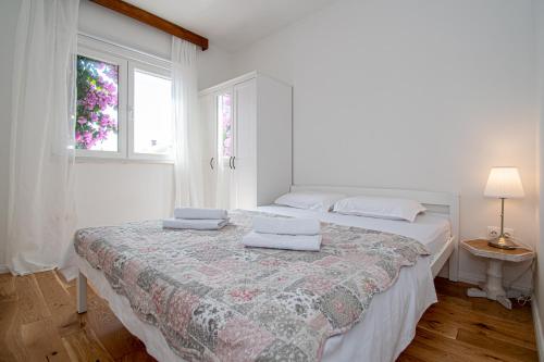 a bedroom with two beds with towels on top of it at Apartment Nikola in Kastel Novi