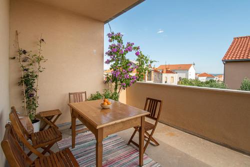 a table and chairs on a balcony with a view at Apartment Nikola in Kastel Novi