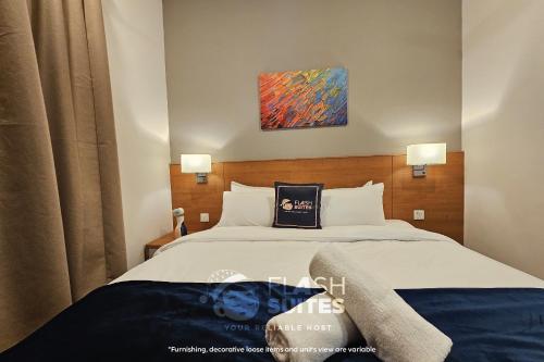 a bedroom with two beds and a painting on the wall at Onsen Premium Suites @ Tambun Ipoh in Ipoh