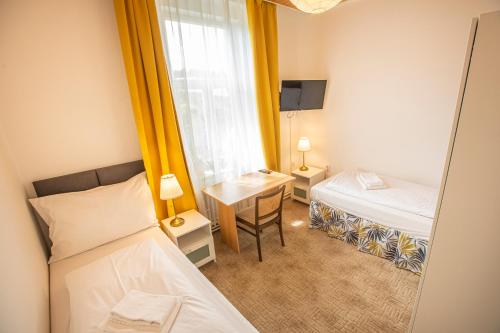 a small room with a bed and a desk at Pension v parku Český Šternberk in Český Šternberk