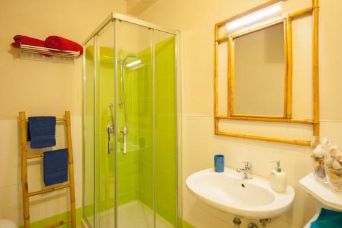 a bathroom with a sink and a glass shower at Villa Bruno in Maruggio