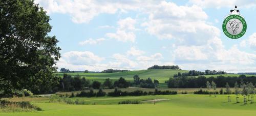 a clock on top of a green golf course at Schlosshotel Klaffenbach in Chemnitz