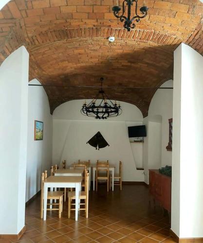 a dining room with a table and chairs and a chandelier at Solar do Encalho in Amareleja