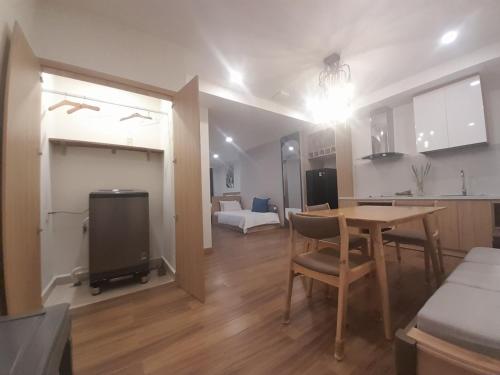 a kitchen and a dining room with a table and a kitchen and a living room at Happy Home in Nha Trang