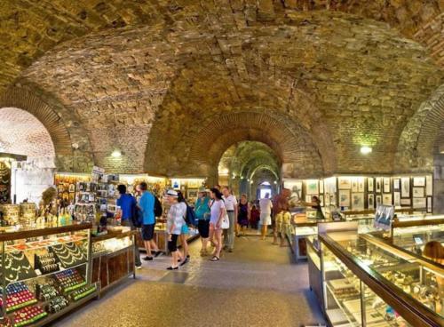 a group of people walking through a market in a building at Unique Apartment in heart of the old town of Split in Split