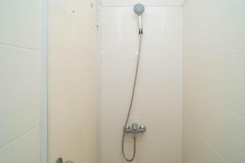 a shower with a shower head in a bathroom at Mroom Residence near UMN Gading Serpong RedPartner in Tjitjajur-hilir