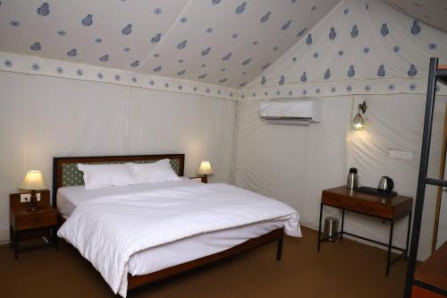 a bedroom with a bed with a blue and white ceiling at Impian Resorts - Jodhpur in Jodhpur