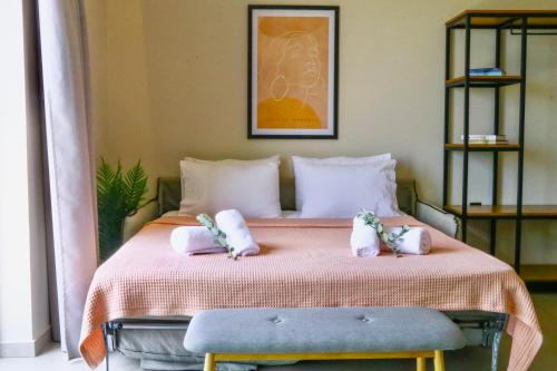 a bedroom with a bed with two towels on it at Petrichor in Kalamata