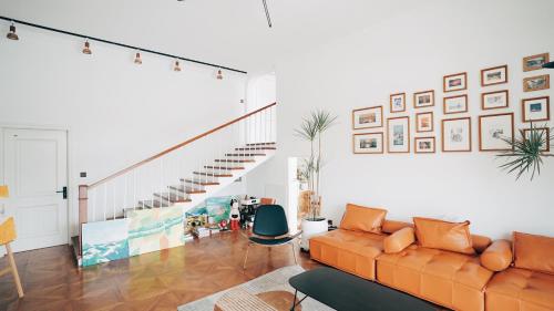 a living room with a couch and a staircase at 峨眉山一方民宿Mount Emei Little Place Guesthous in Emeishan
