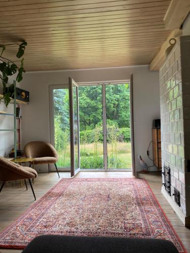 a living room with a large sliding glass door at Cisze Kamieniec in Kamieniec