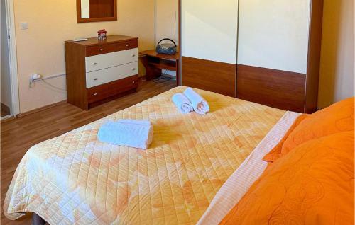 a bedroom with a bed with two towels on it at 1 Bedroom Cozy Home In Knin in Vrbnik