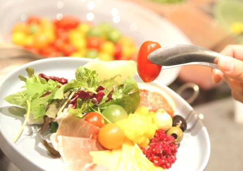 a plate of food with a salad on a table at Oriental Hotel Fukuoka Hakata Station in Fukuoka