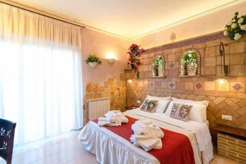 a bedroom with a bed with towels on it at Casa della Giara in Giarre