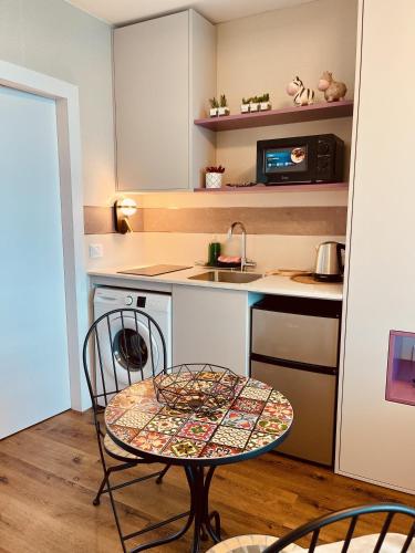 a small kitchen with a table and a sink at C Tower Premium Apartments, Panoramic Sea View in Netanya