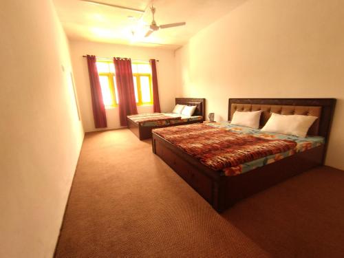 a bedroom with a bed and a couch in it at Hotel city way in Srinagar