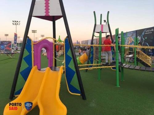 a playground with a yellow and blue slide at شاليه بورتوسعيد in Port Said