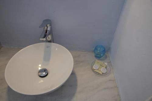 a white toilet in a bathroom with a sink at Andriani's Guest House in Mýkonos City