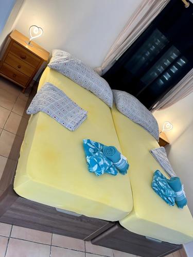 a yellow couch with bow ties on top of it at Wg1 Benidorm in Benidorm