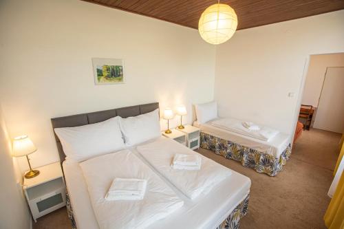 a bedroom with two beds and a couch in it at Pension v parku Český Šternberk in Český Šternberk