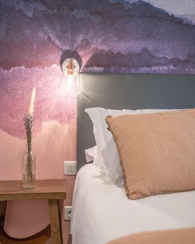 a bedroom with a bed and a table with a candle at Résidence U Frusteru in Propriano