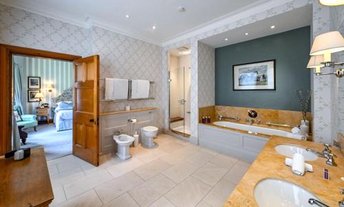 a bathroom with a tub and a toilet and a sink at The Jockey Club Rooms in Newmarket