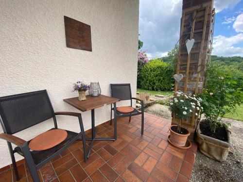 a patio with two chairs and a table and a table at Ferienhaus 40 in Egloffstein