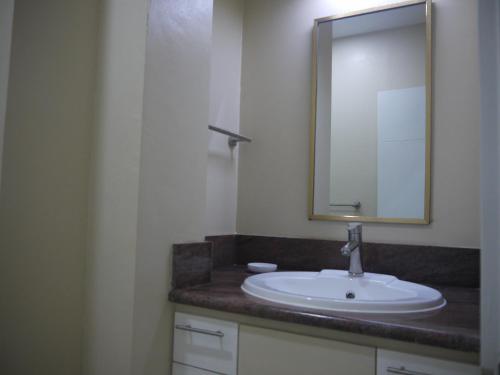 a bathroom with a sink and a mirror at Casita A in Pagudpud