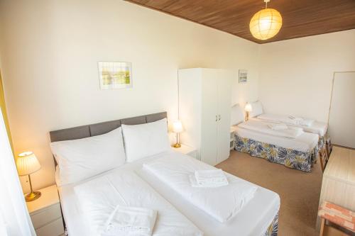 a bedroom with a bed and two beds in it at Pension v parku Český Šternberk in Český Šternberk