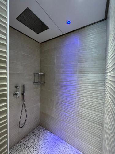 a bathroom with a shower with a shower head at Hotel Mon Pays in Riccione