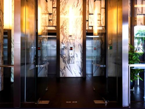 a row of elevators in a building with a door at D'CASA Bintang Fairlane at Bukit Bintang in Kuala Lumpur