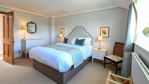 a bedroom with a large bed and two night stands at The Jockey Club Rooms in Newmarket