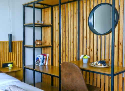 a room with a wooden wall with a table and a mirror at Petrichor in Kalamata
