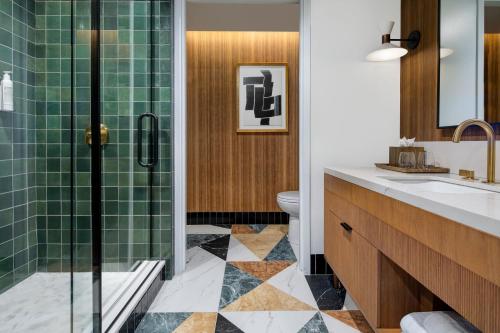 a bathroom with a shower and a toilet and a sink at Le Méridien Salt Lake City Downtown in Salt Lake City