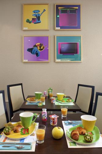 a dining room table with plates of food on it at ibis Styles Belfort Centre in Belfort
