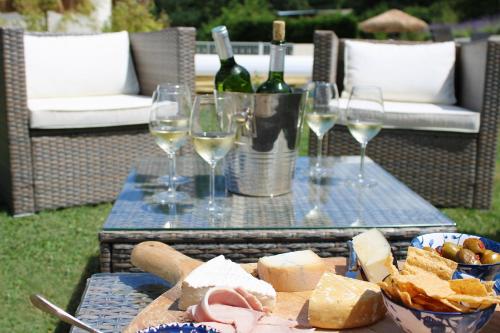 a table topped with glasses of wine and cheese at Les Rocailles in Lamonzie-Montastruc