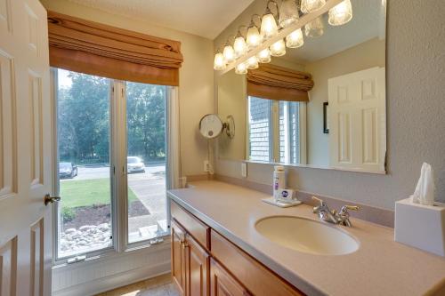 ein Bad mit einem Waschbecken, einem Spiegel und einem Fenster in der Unterkunft Williamsburg Condo Rental 3 Mi to Busch Gardens! in Williamsburg