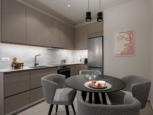 a kitchen with a table and chairs in a kitchen at Ares Luxurious Residence in Kolymvari