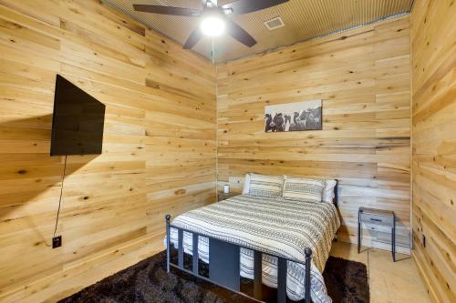 a bedroom with a bed in a wooden wall at Burkesville Cabin, 3 Mi to Dale Hollow Lake! in Frogue
