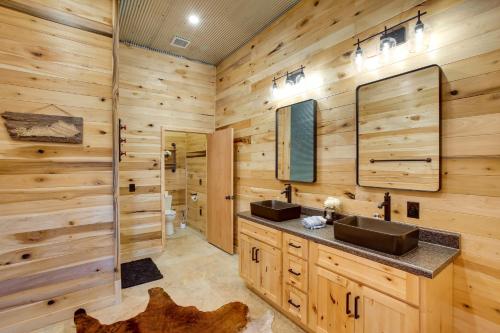 a log cabin bathroom with two sinks and a shower at Burkesville Cabin, 3 Mi to Dale Hollow Lake! in Frogue