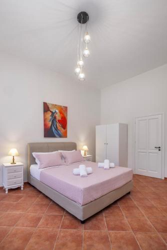 a bedroom with a large bed with two night stands at Nikolas Old Town in Rhodes Town