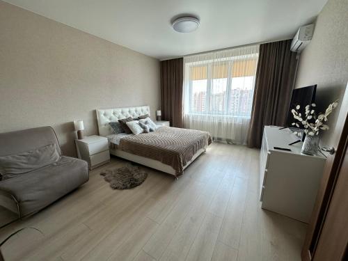 a living room with a bed and a couch at Apartment, Podillya in Vinnytsya