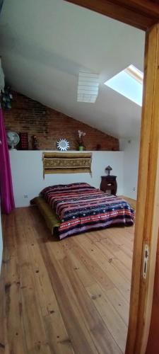 a bedroom with a bed in the middle of a room at Maison Béline in Moissac