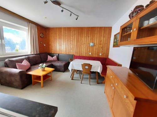 a living room with a couch and a table at Appartement Schilcher in Oberau